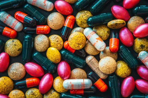 a pile of different colored pills