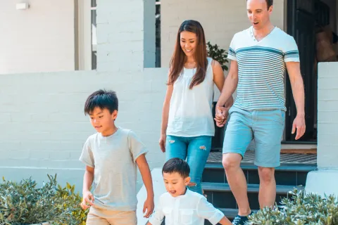 a family walking down a sidewalk