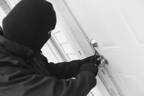 a thief breaking into a house