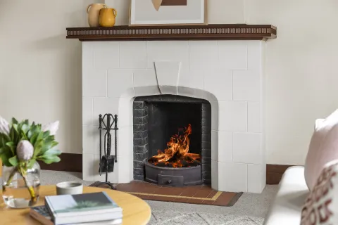 a fireplace with a wood shelf