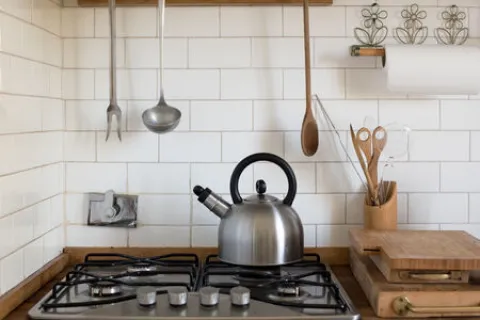 a kitchen with a stove and a pot on the stove