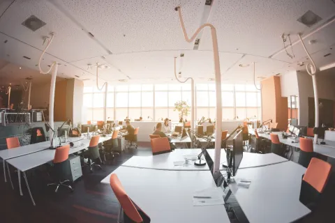 an office with tables and chairs