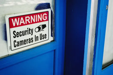 a security sign on a blue door