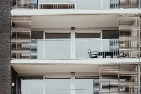 a building with many balconies and sliding glass doors