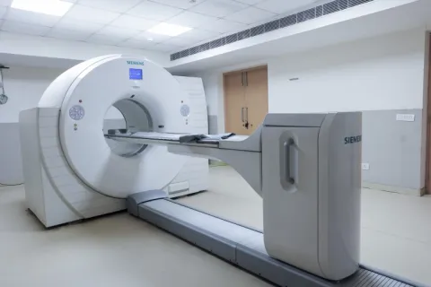 Siemens MRI scanner in a clean hospital room with white walls and tiled flooring