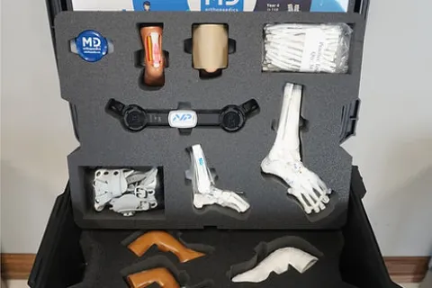 Medical kit displaying educational models and tools for understanding and treating clubfoot.
