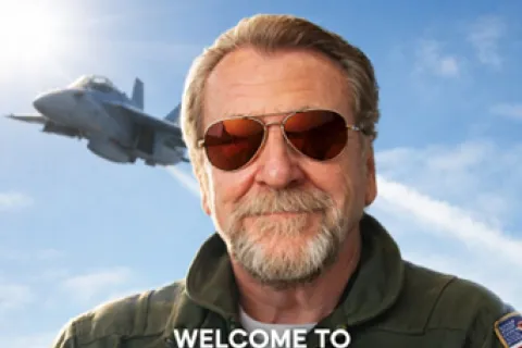 Smiling man in aviator sunglasses and flight jacket with jet fighter flying in background and Top Gun for Therapists text.