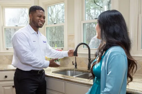 a man and a woman standing in a kitchen