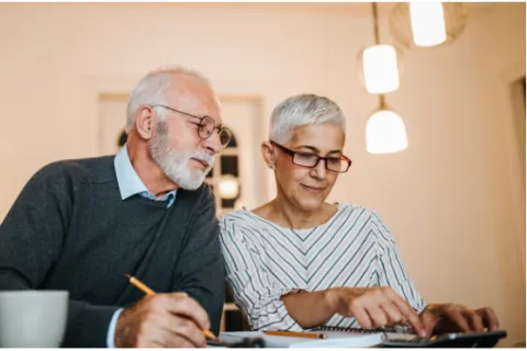 a man and a woman looking at a computer