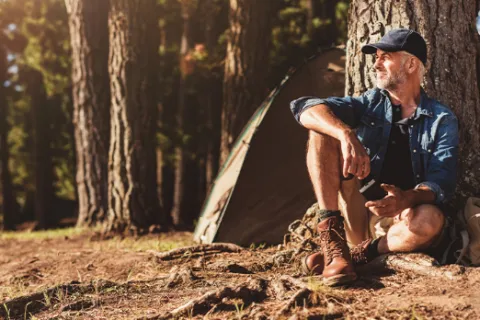 a man sitting in a forest