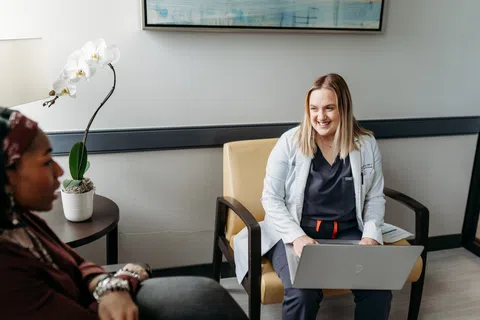A bariatric surgeon reviewing a patient's health history during a consultation at an Atlanta weight loss surgery clinic.