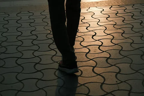 Close-up photograph of a person's lower legs and ankles, representing the heaviness and swelling that can be an early sign of venous insufficiency.