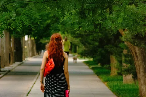 Close-up of a person's legs walking outdoors, representing the visible leg skin changes that can signal underlying chronic venous insufficiency rather than simple eczema.