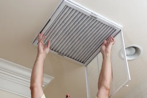 a person changing an air filter