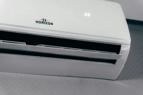 White Horizon wall-mounted air conditioner showing digital temperature display and open air vents.