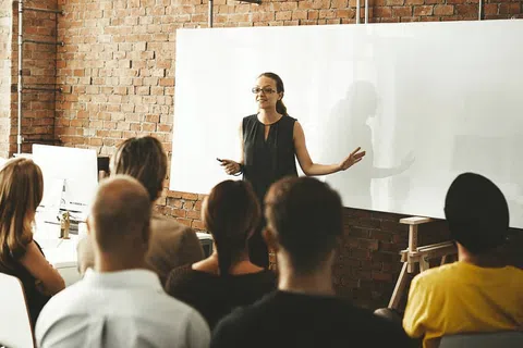 a person standing in front of a group of people