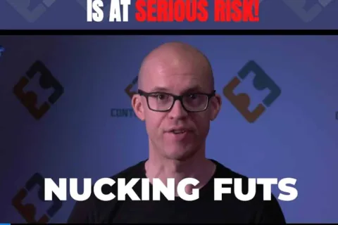 a bald man wearing glasses
