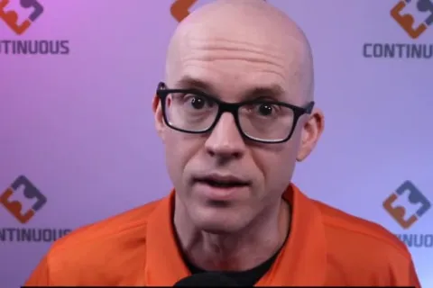 a bald man wearing glasses
