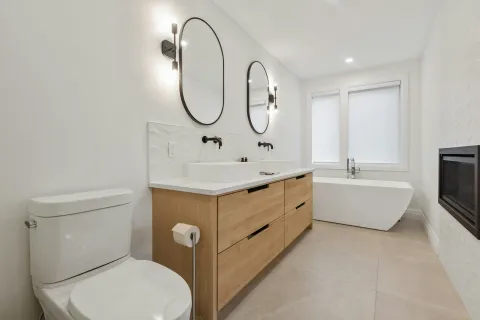a bathroom with a tub sink and toilet