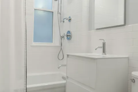 a bathroom with a shower and toilet