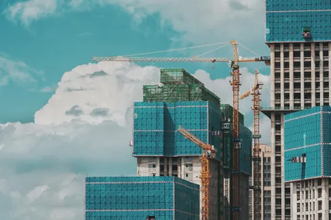 a group of cranes and buildings