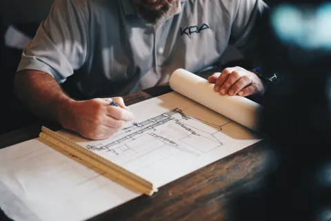 a man writing on a piece of paper