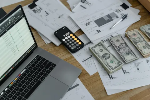 a laptop and several papers