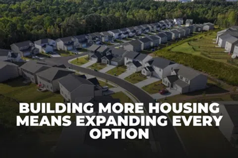 Aerial view of suburban neighborhood with rows of houses and tree-lined background with housing expansion text.