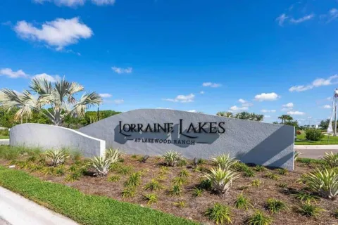 Entrance sign for Lorraine Lakes at Lakewood Ranch with landscaping under a blue sky.
