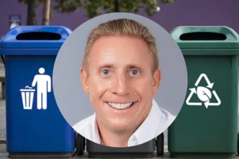 Smiling man superimposed over blue trash and green recycling bins outdoors with trees and wall background.