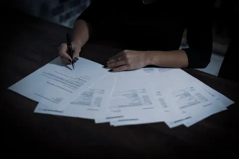 a person writing on a piece of paper