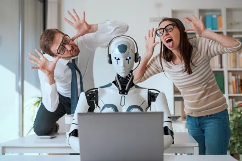 a man and woman looking at a computer screen
