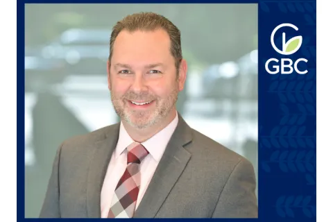 greg mcalvin a man in a suit smiling