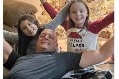 Granite Garage Floors franchise awarded to Nate Baker of Latrobe, PA with family photo by Christmas tree.