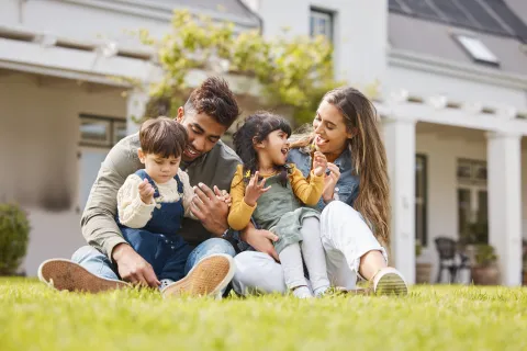 a family sitting on the grass