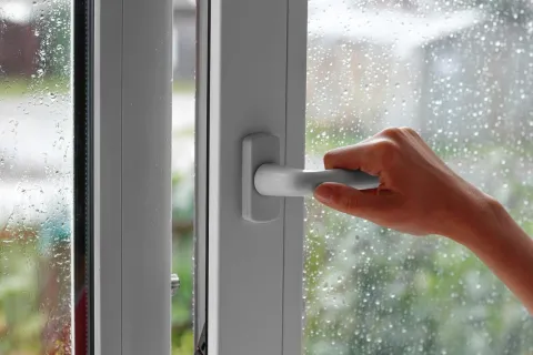 a hand holding a door handle