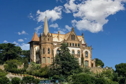 a large castle with trees in front of it