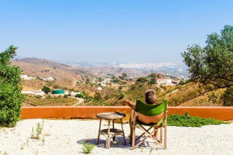 a person sitting at a table overlooking a town