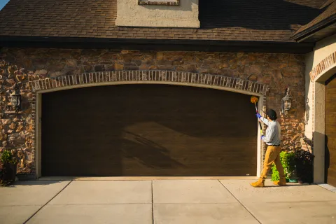 Pest control technician sweeping for spider webs to remove any existing cobwebs and spiders.