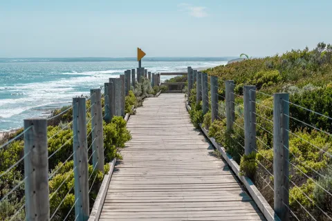 a wooden walkway to a beach