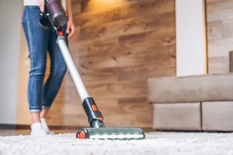 a person using a vacuum cleaner