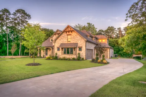 a house with a driveway and trees