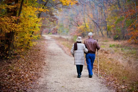 a couple walking on a dirt road