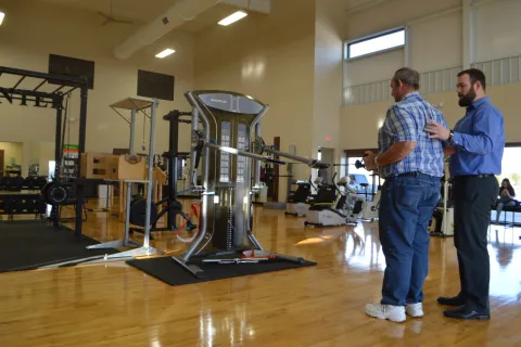 men standing next to a machine