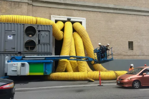 Professional duct cleaning truck servicing a Monroe GA home with yellow vacuum hoses