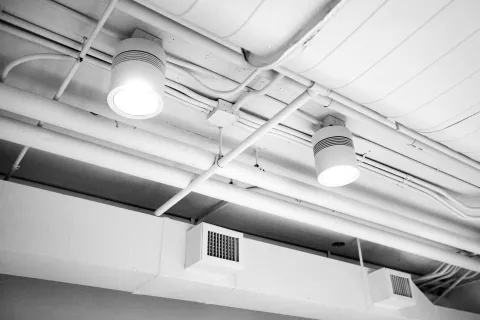 Exposed ductwork running across a ceiling, similar to the systems found in many Monroe, GA homes.