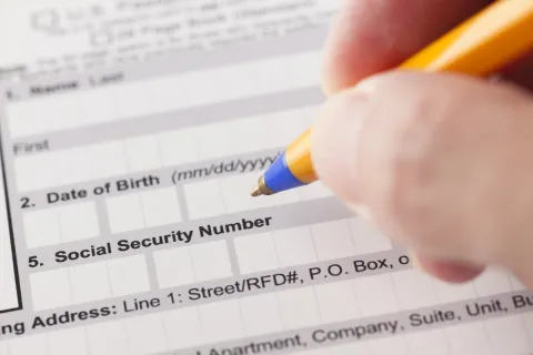 a pen filling out a form