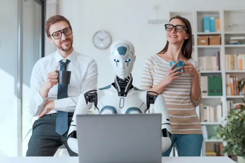a man and a woman holding microphones and a laptop