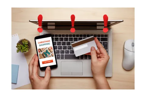 a hand with a phone and a credit card