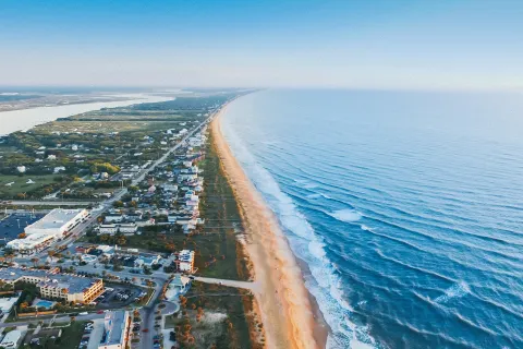 a beach with buildings and water